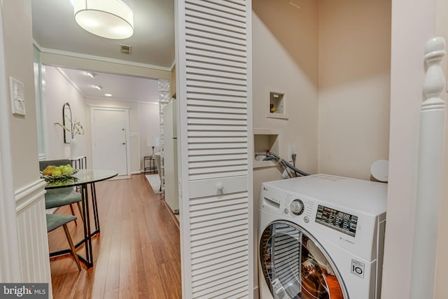 laundry room with washer / clothes dryer, light wood-type flooring, and ornamental molding