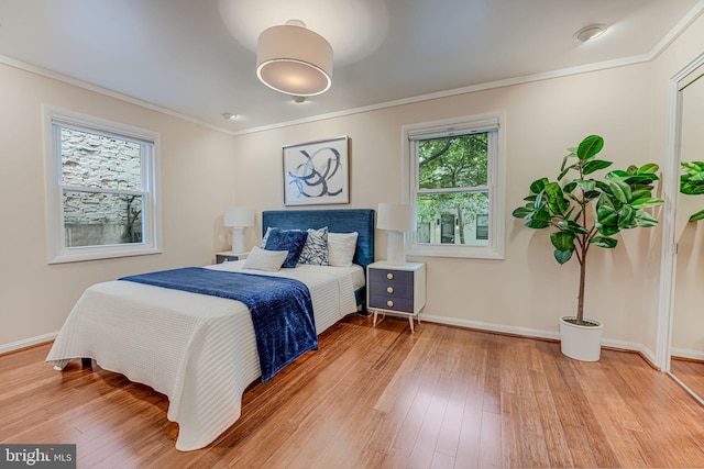 bedroom featuring wood-type flooring and crown molding