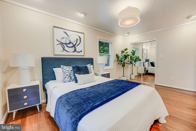 bedroom featuring ornamental molding, dark hardwood / wood-style floors, and a closet