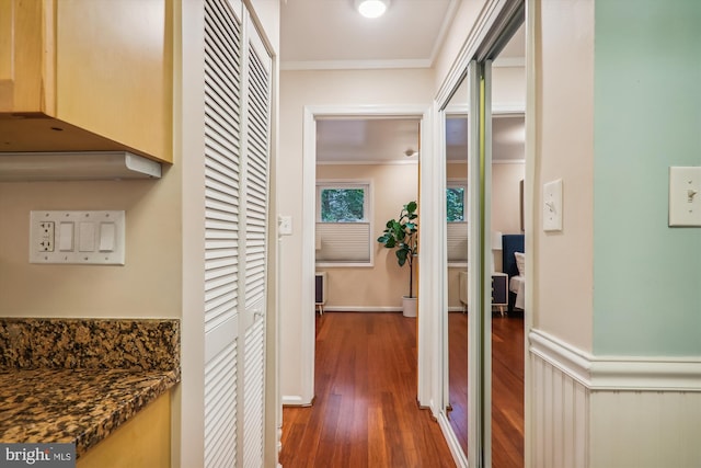 hall featuring crown molding and dark wood-type flooring