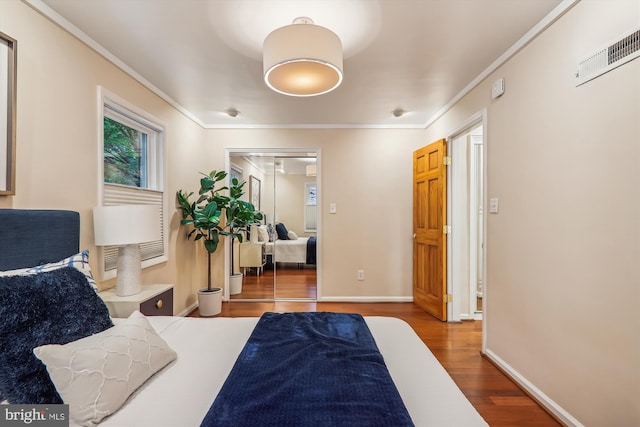 bedroom with wood-type flooring and ornamental molding