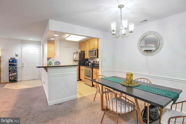 carpeted dining area featuring a chandelier