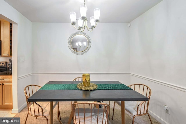 tiled dining area featuring a notable chandelier