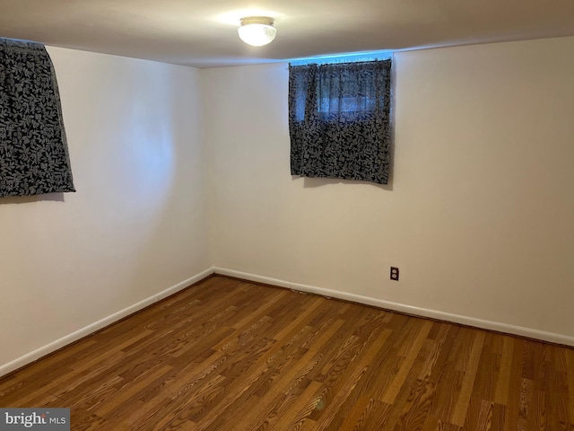 empty room featuring baseboards and wood finished floors