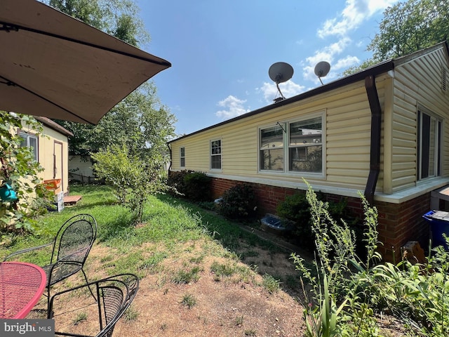 view of home's exterior with a yard