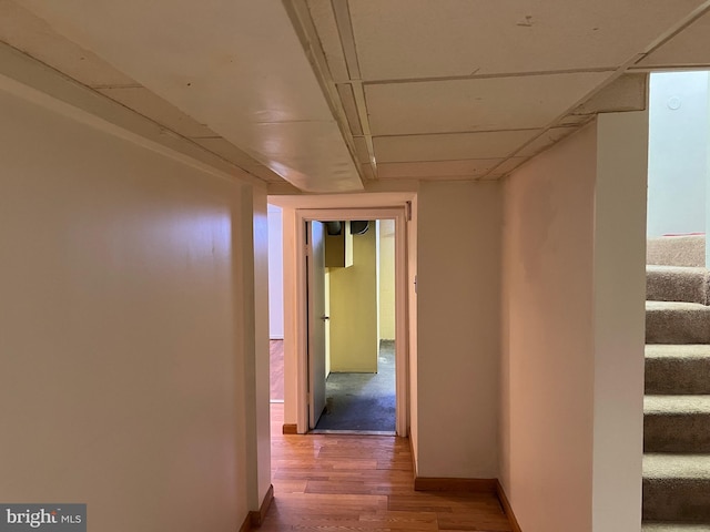 hall featuring stairway, baseboards, and wood finished floors