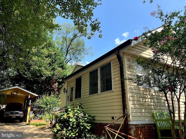 view of home's exterior featuring a carport and crawl space