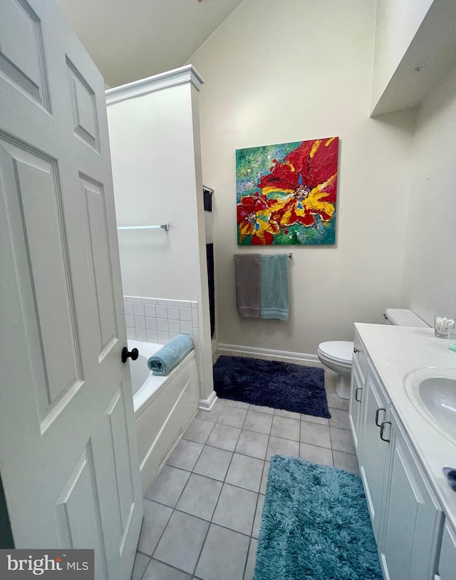 bathroom featuring tile patterned flooring, a bathtub, toilet, and vanity