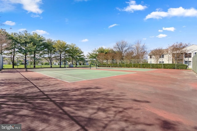 view of tennis court with basketball hoop