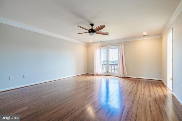 empty room featuring dark hardwood / wood-style flooring, ceiling fan, and crown molding