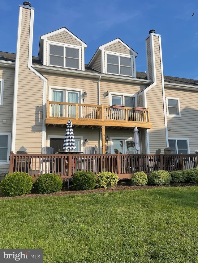 rear view of property with a yard