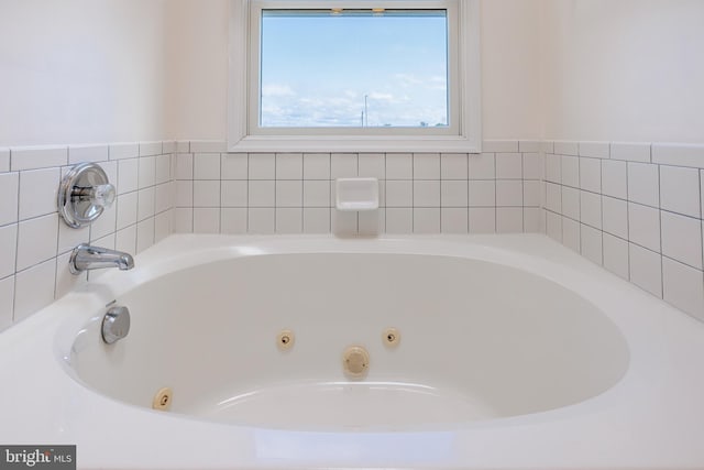 bathroom with a tub to relax in