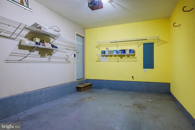 garage featuring electric panel and a garage door opener