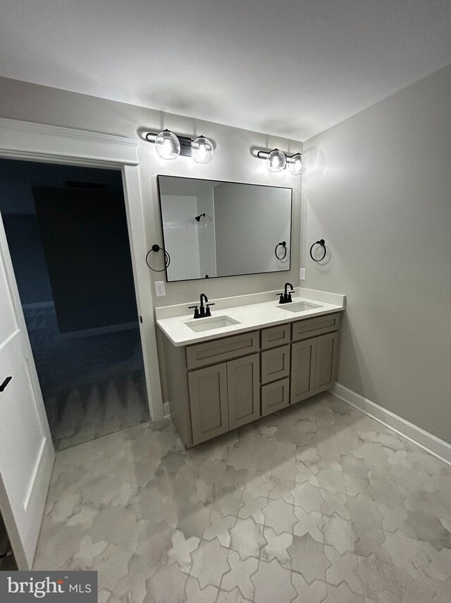 22430 Hummingbird Rd, Ellendale, DE 19941 - full bathroom featuring baseboards, a sink, marble finish floor, and double vanity