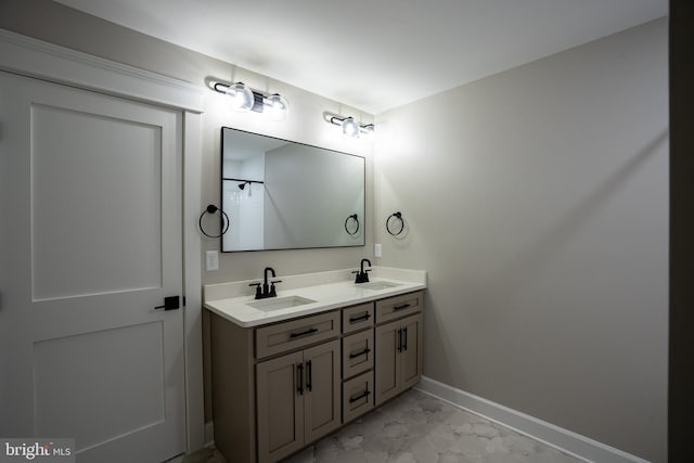 22430 Hummingbird Rd, Ellendale, DE 19941 - full bathroom with double vanity, baseboards, a sink, and marble finish floor