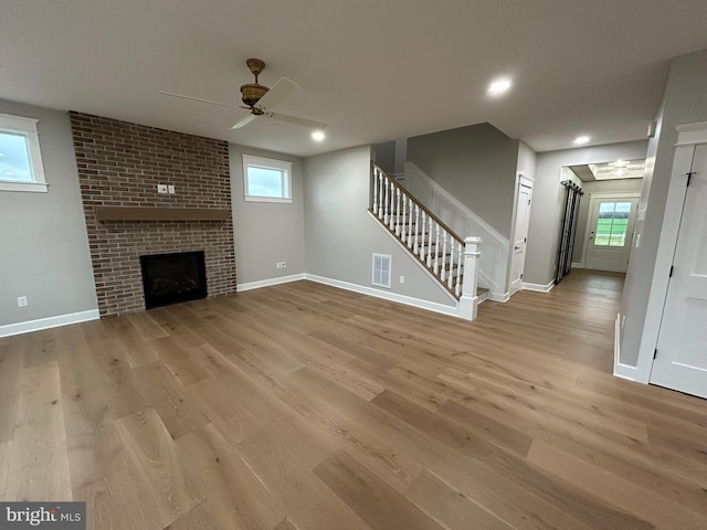 22430 Hummingbird Rd, Ellendale, DE 19941 - unfurnished living room with visible vents, stairs, wood finished floors, baseboards, and a ceiling fan