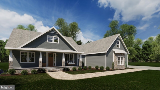 craftsman house featuring covered porch and a front yard