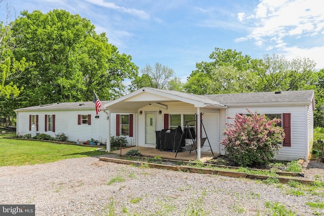 single story home with a patio and a front lawn