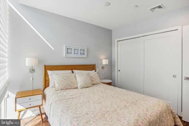 bedroom featuring light hardwood / wood-style floors and a closet