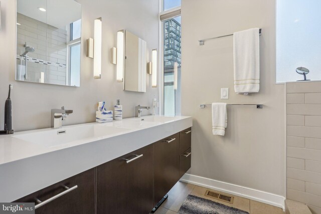 bathroom featuring tile patterned floors, vanity, and tiled shower