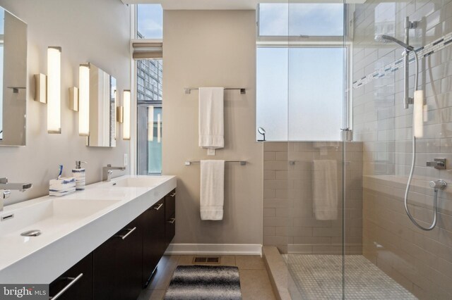 bathroom with tile patterned floors, vanity, and a shower with shower door