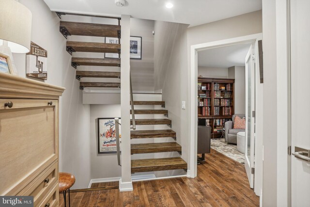 staircase featuring wood-type flooring