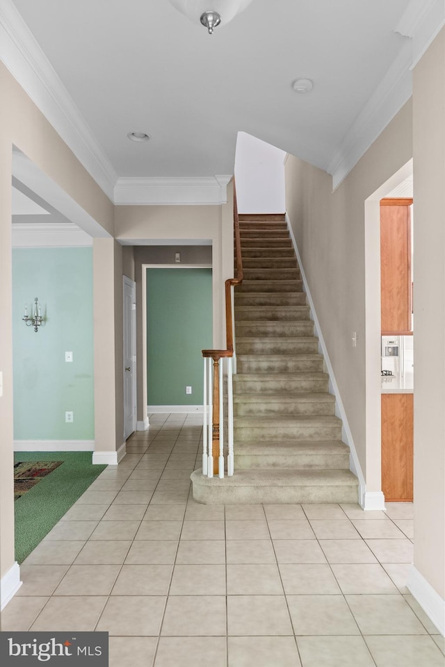 stairs with tile patterned flooring and ornamental molding