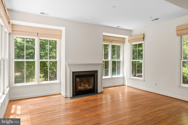 unfurnished living room with light hardwood / wood-style flooring