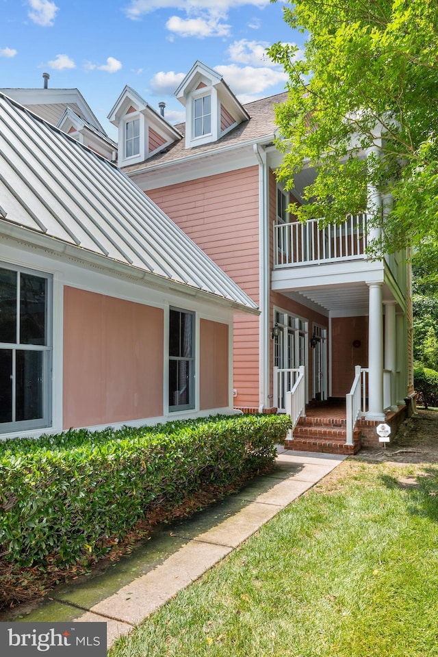 view of side of home with a lawn