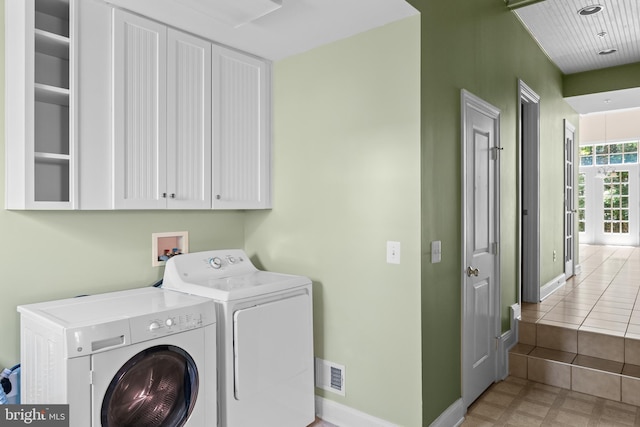 laundry area featuring cabinets and washing machine and dryer