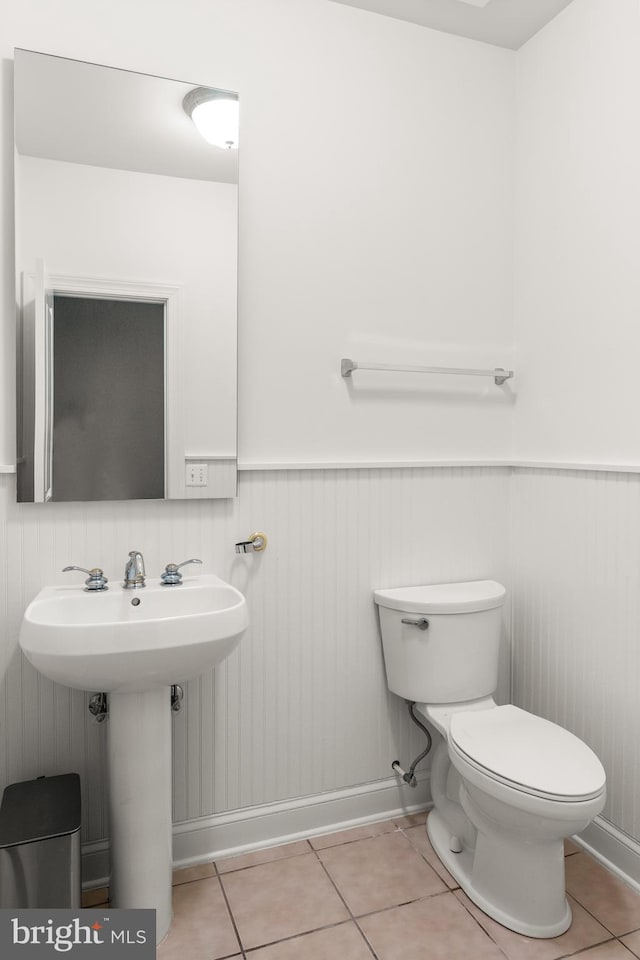 bathroom with tile patterned floors, sink, and toilet