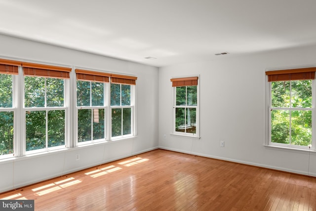 unfurnished room with light hardwood / wood-style flooring