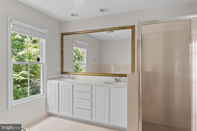 bathroom featuring vanity, tile patterned floors, and walk in shower