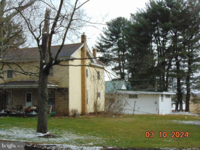 view of side of property with a yard