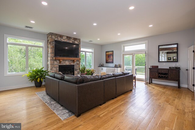 living room featuring light hardwood / wood-style floors and a fireplace