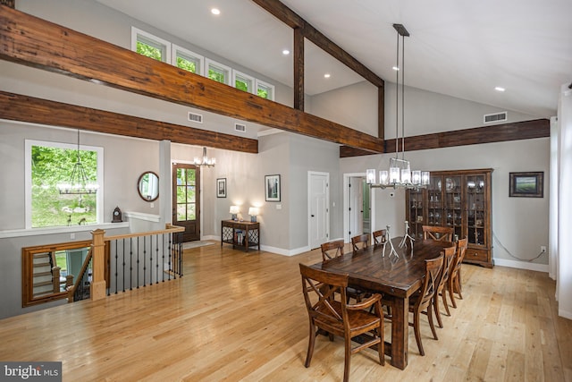 dining area with light hardwood / wood-style flooring, beam ceiling, and a chandelier