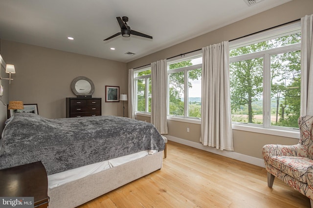 bedroom with ceiling fan and light hardwood / wood-style floors