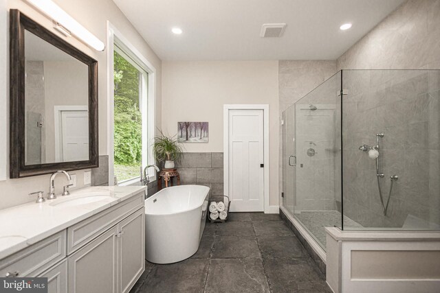 bathroom with vanity and plus walk in shower