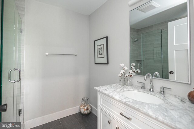 bathroom featuring walk in shower and vanity