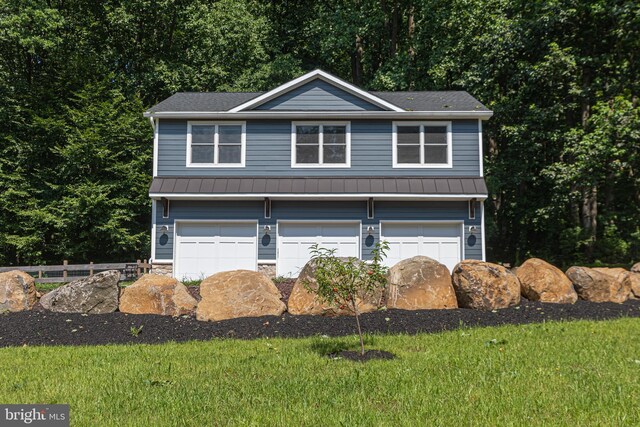 exterior space featuring a front yard and a garage