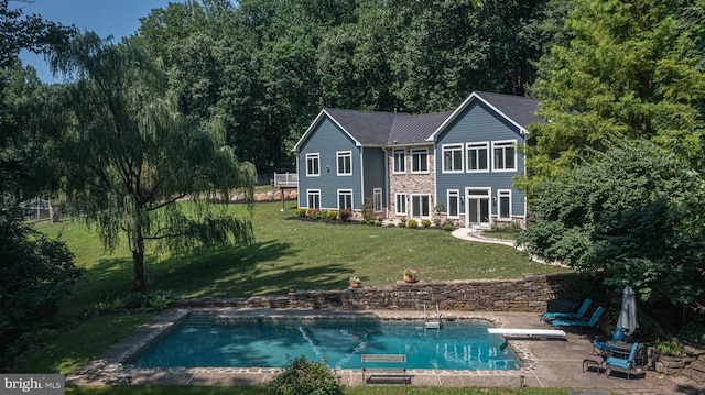 rear view of house with a patio area and a yard