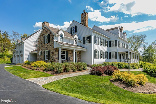 view of front of home with a porch and a front lawn