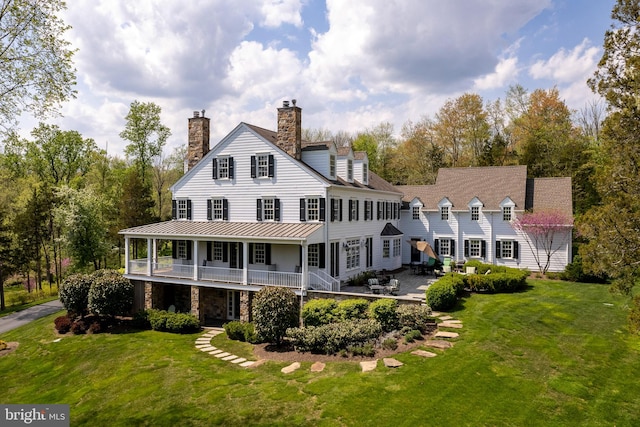 rear view of house with a lawn