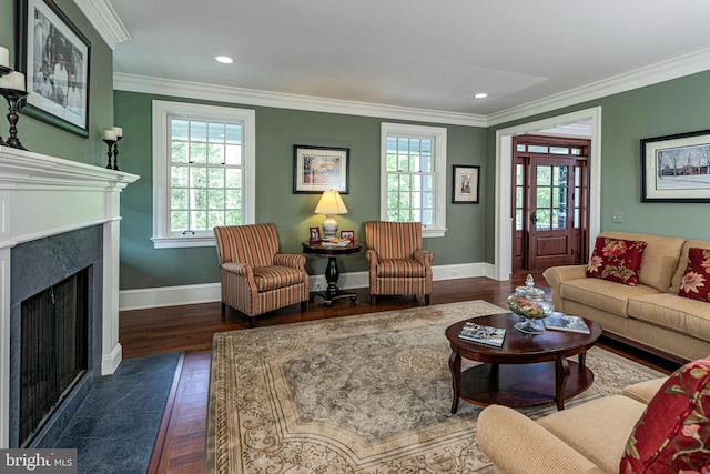 living room with a high end fireplace, dark hardwood / wood-style flooring, and crown molding