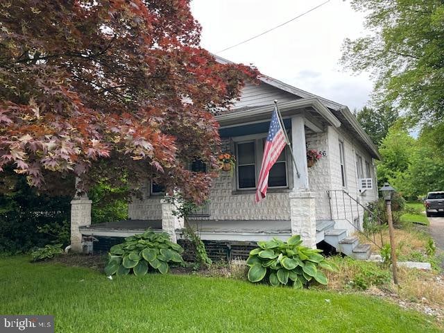 view of side of home featuring a lawn