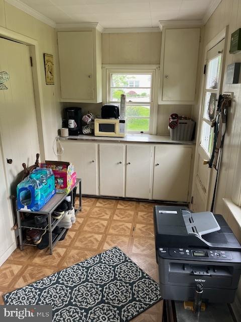 kitchen featuring light parquet flooring and crown molding