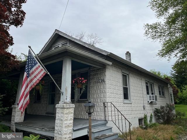 view of property exterior featuring covered porch