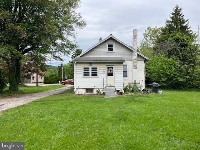 rear view of property with a yard