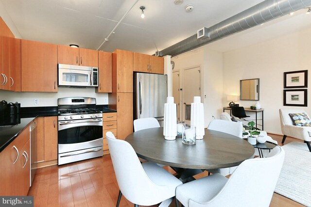 kitchen featuring stainless steel appliances and light hardwood / wood-style floors