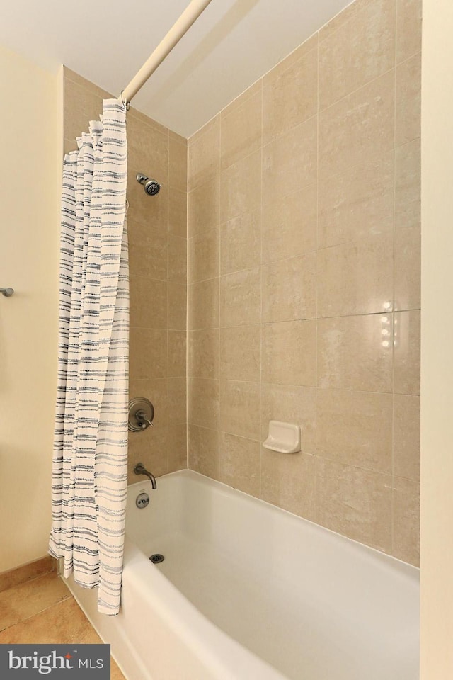 bathroom featuring tile floors and shower / bathtub combination with curtain